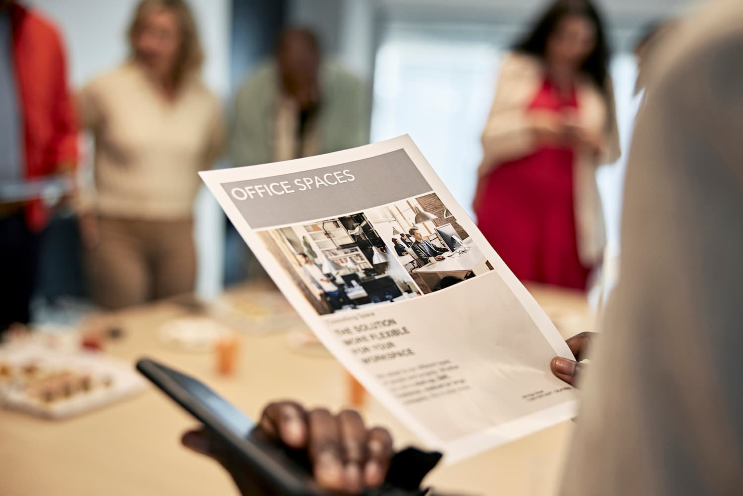 person holding a business flyer